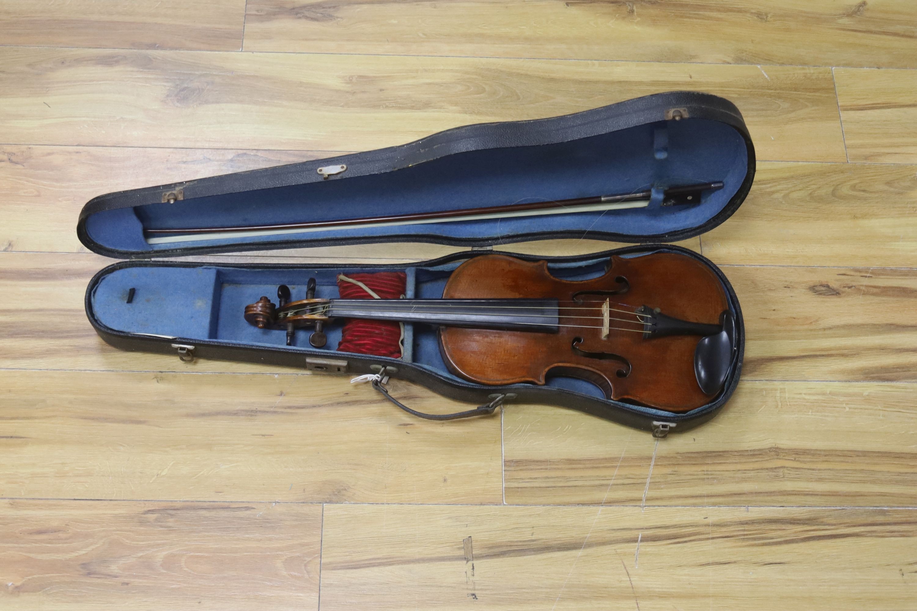 A cased violin and bow